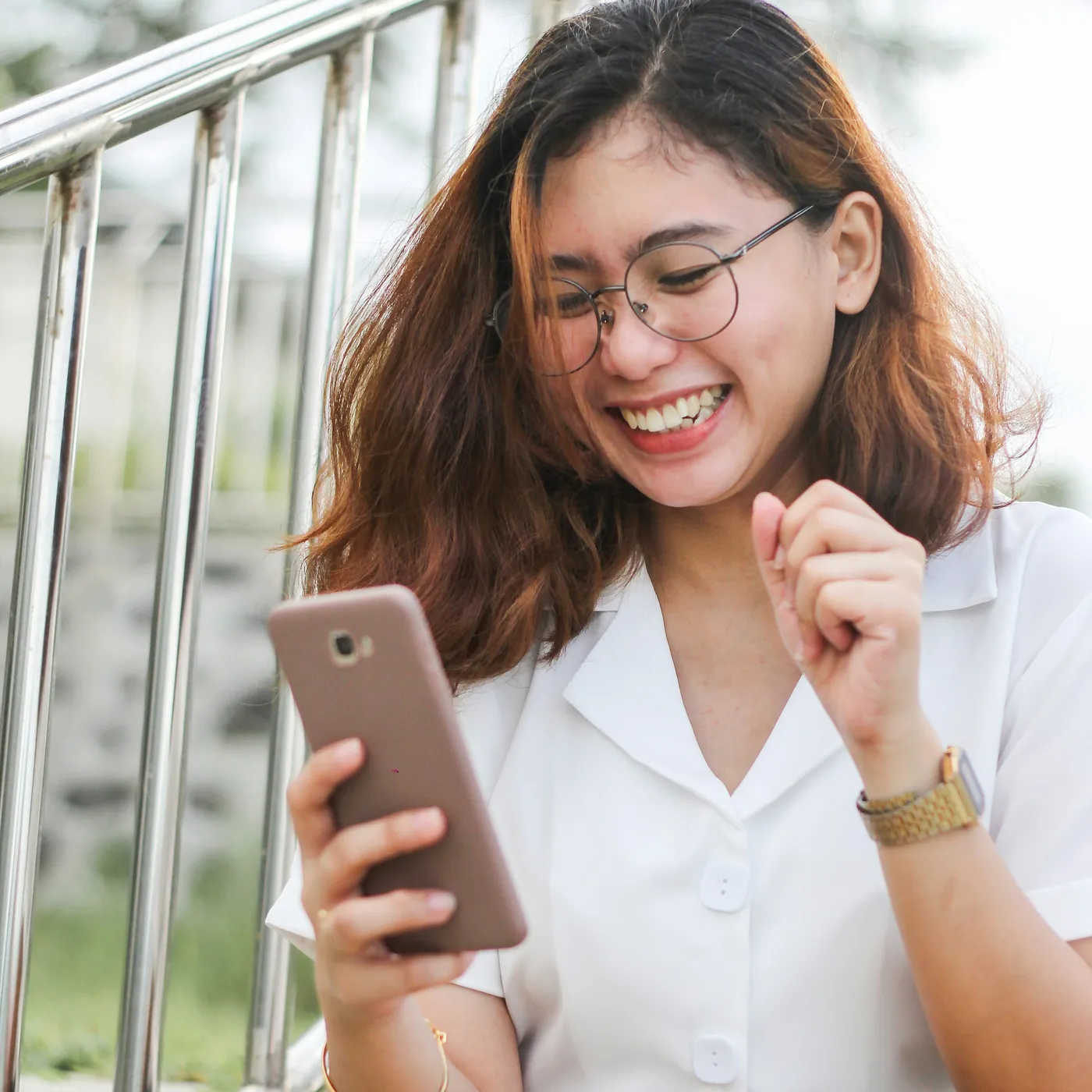 Smiling woman holding her phone