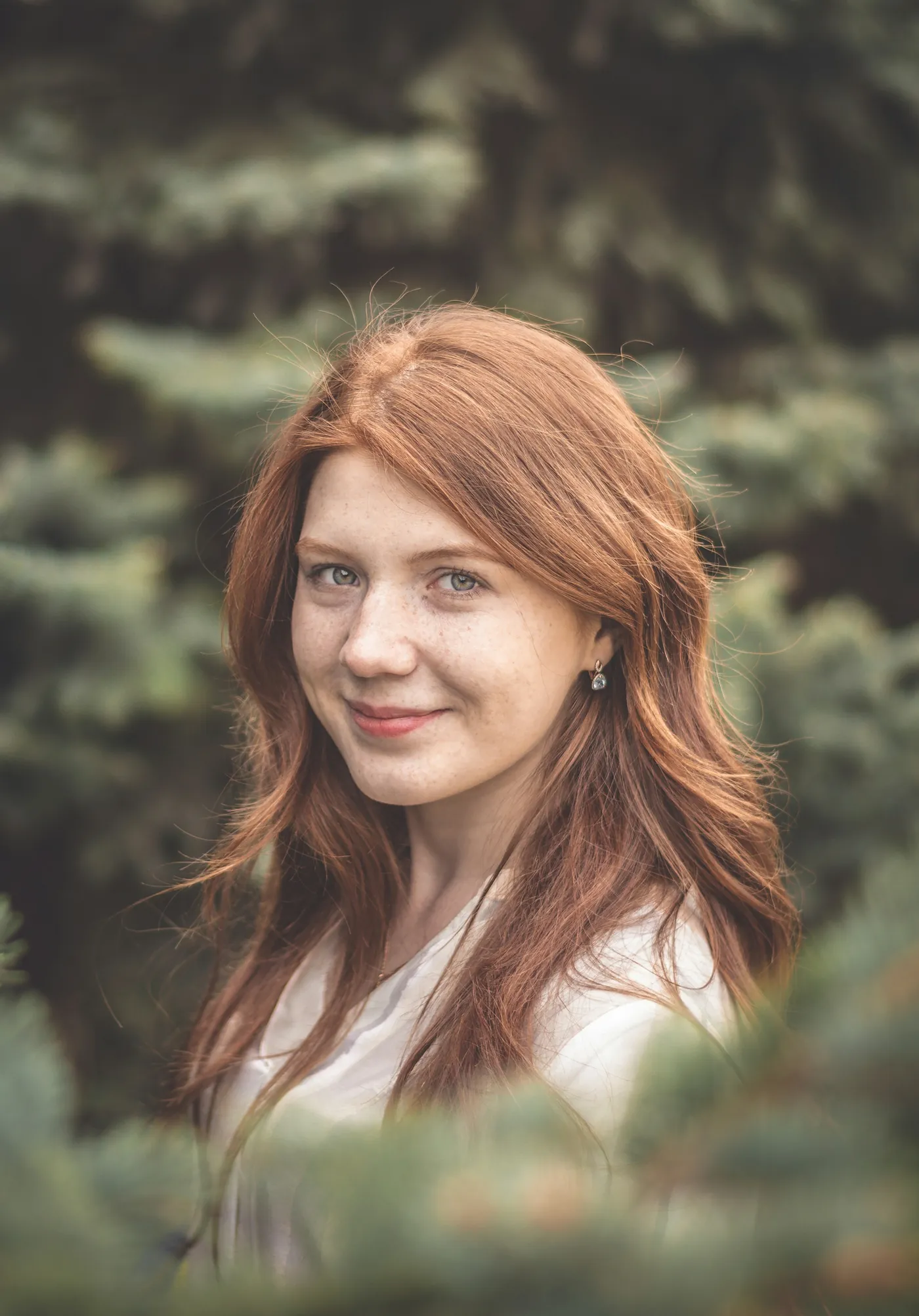 Smiling woman outdoors among greenery