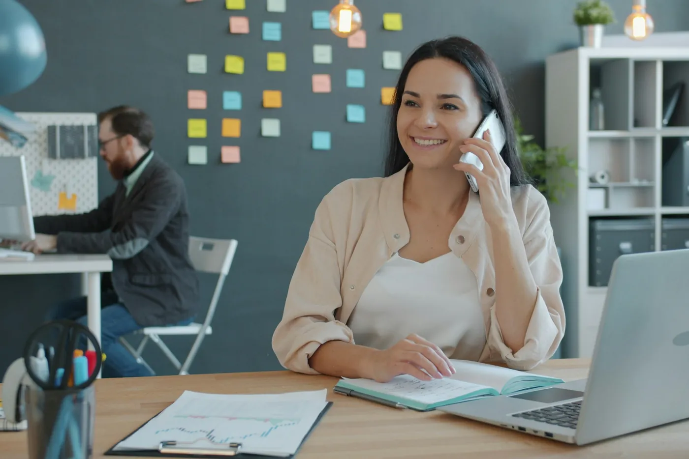 Woman smiling during a phone call at her desk