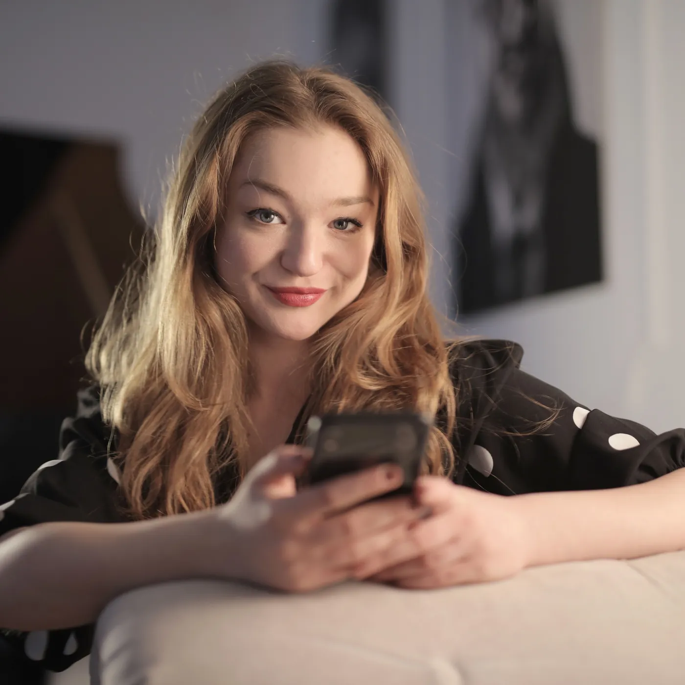 Smiling woman reading a message on her phone