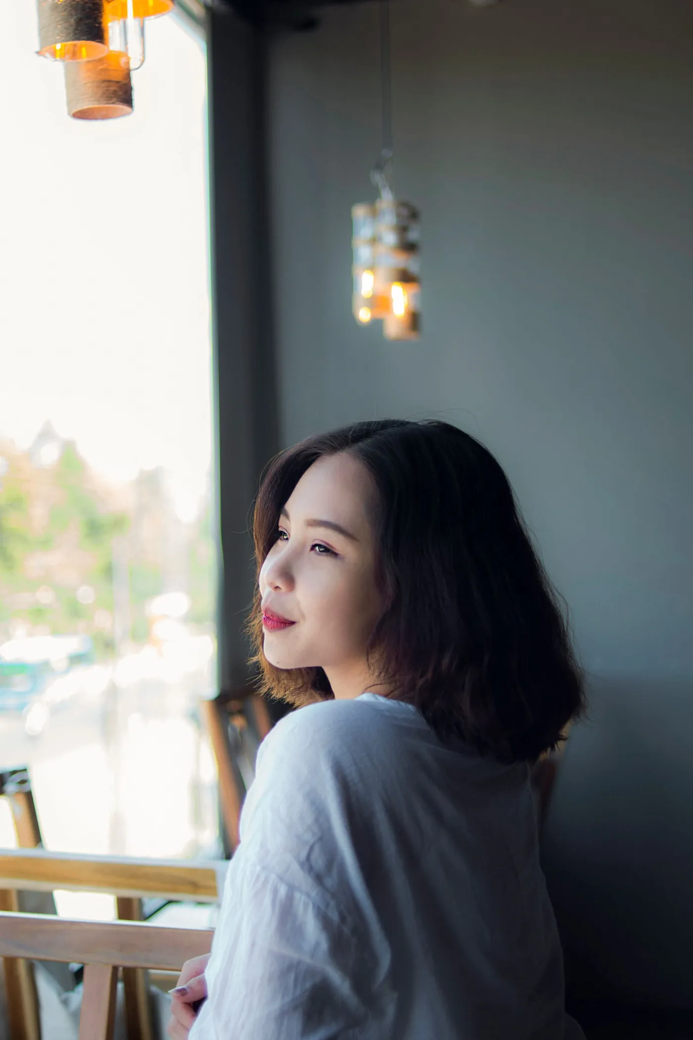 Woman looking out of a window, thinking