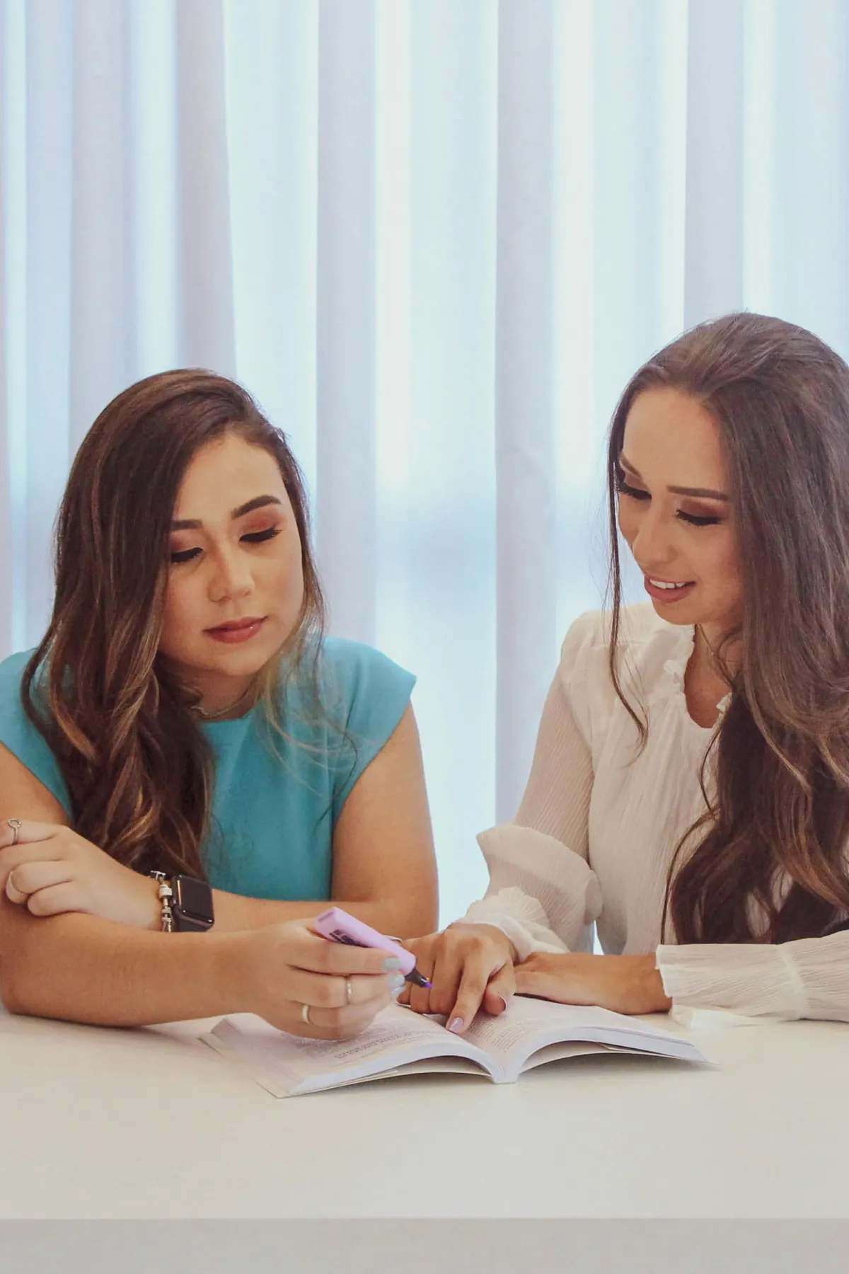 Two women reviewing a personal plan together at a table