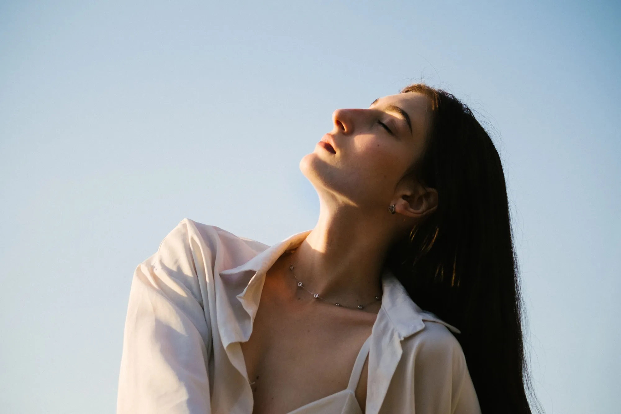 Woman with smooth skin in soft sunlight